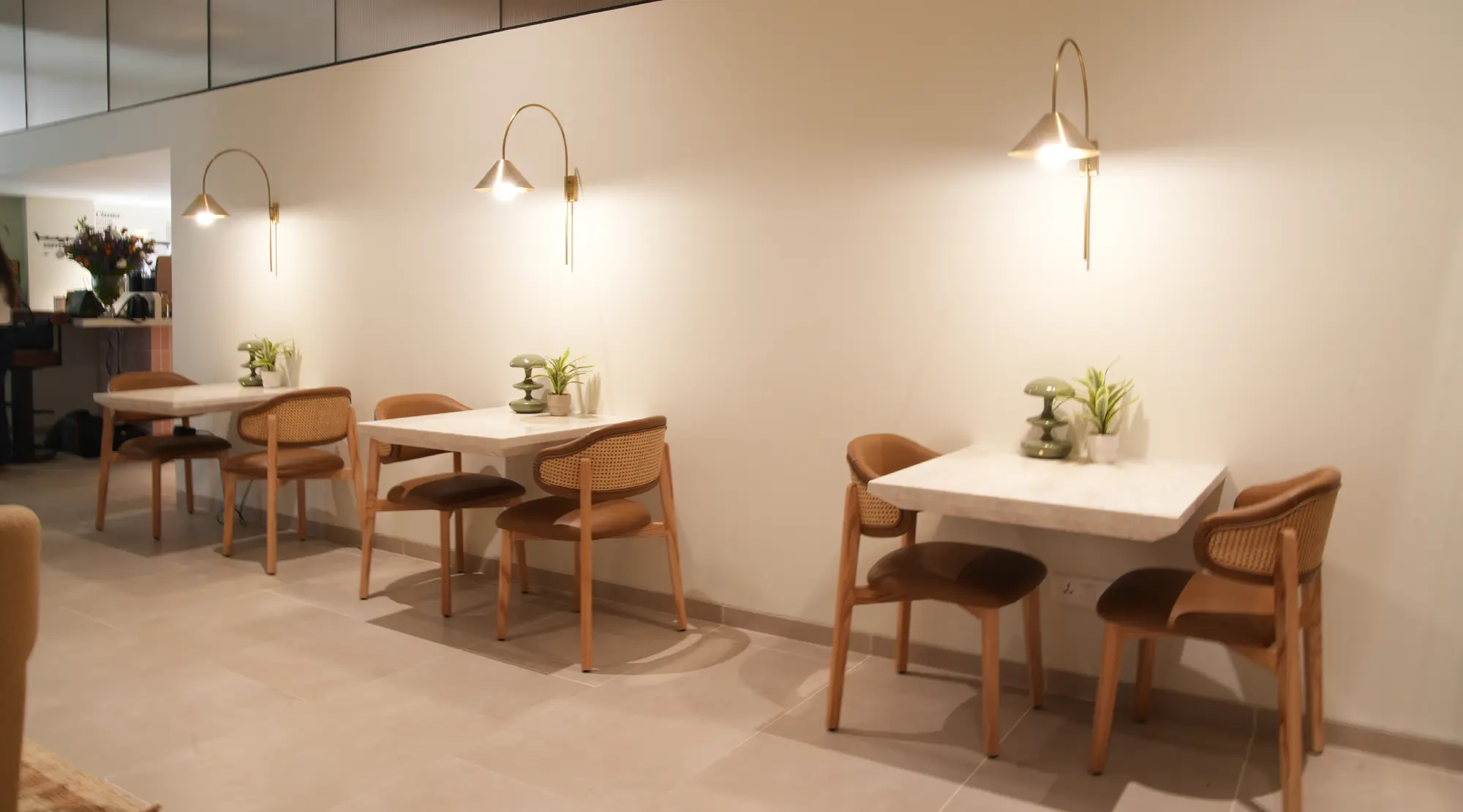 Seating at the Unlock Everyday coffee bar with warm pendant lighting
