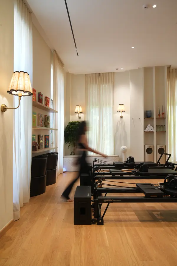 A Pilates class in session on reformer machines at Unlock Everyday